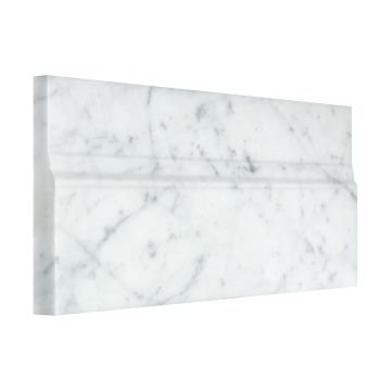 Angled view of the 5" x 12" base molding in Carrara Claro Light honed marble.
