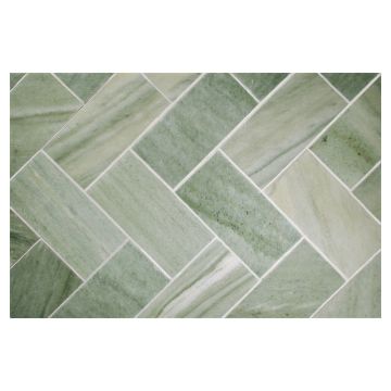 3" x 6" subway tile in honed Canopy Green marble, laid out in a herringbone pattern.