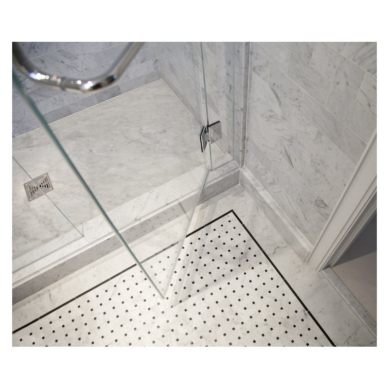 The basketweave mosaic is used for the bathroom floor, made from Carrara marble with Nero Marquina dots, from the Complete Tile Collection.