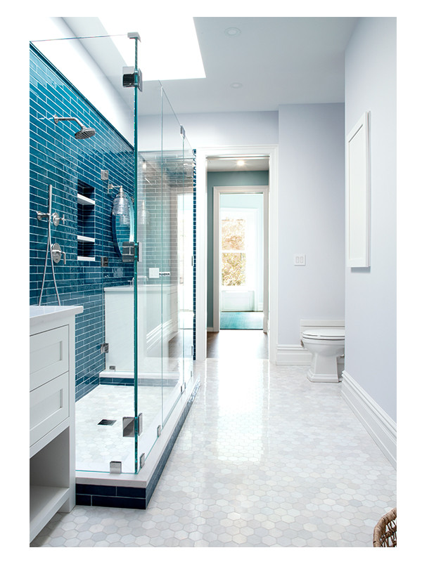A blue children's bathroom design by Megan Clark Eisenberg, utilizing the Hexagon Honey mosaic in Blue Caress Light polished marble on the floor.