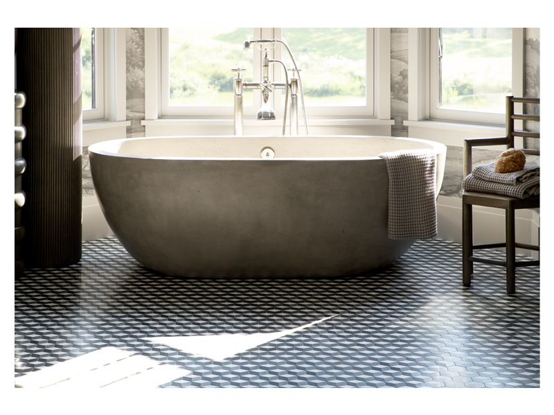The solid cement tub is beautifully set on the Optic Cube mosaic from the Complete Tile Collection. The mosaic is made from honed Thassos and Bardiglio marble with Basalt.