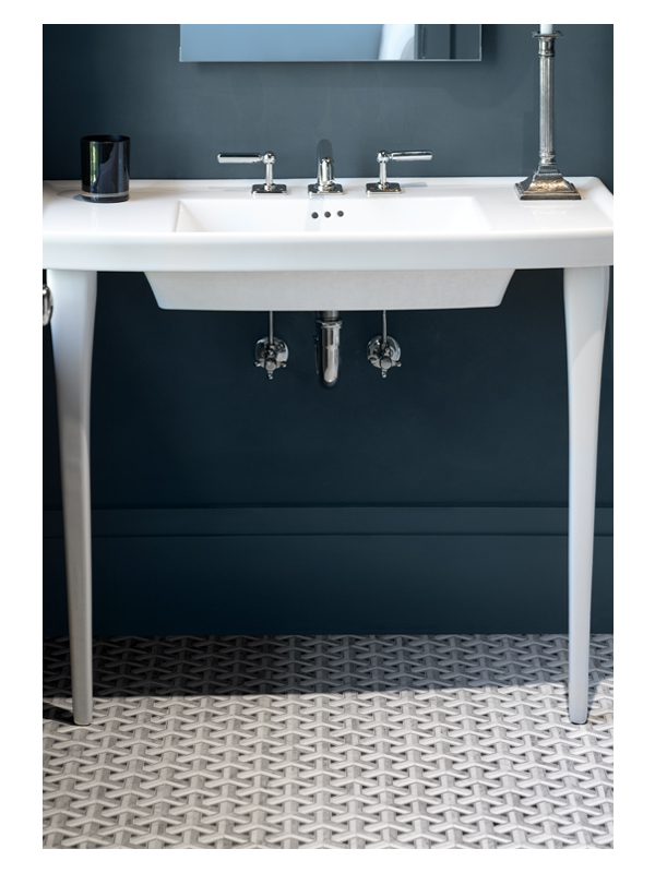 The vanity detail of this guest bathroom by Rocky Rochon. The sophisticated blue walls pair perfectly with the Amberton Weave marble mosaic from the Complete Tile Collection.