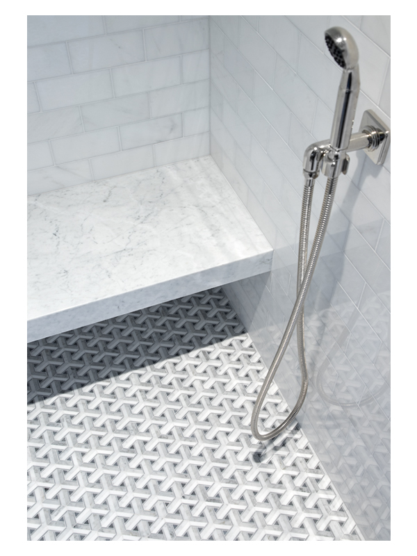A detailed shot of the Amberton Weave mosaic tile by the Complete Tile Collection on this guest shower floor. This intricate pattern is made from Thassos, Carrara, and Bardiglio polished marble.