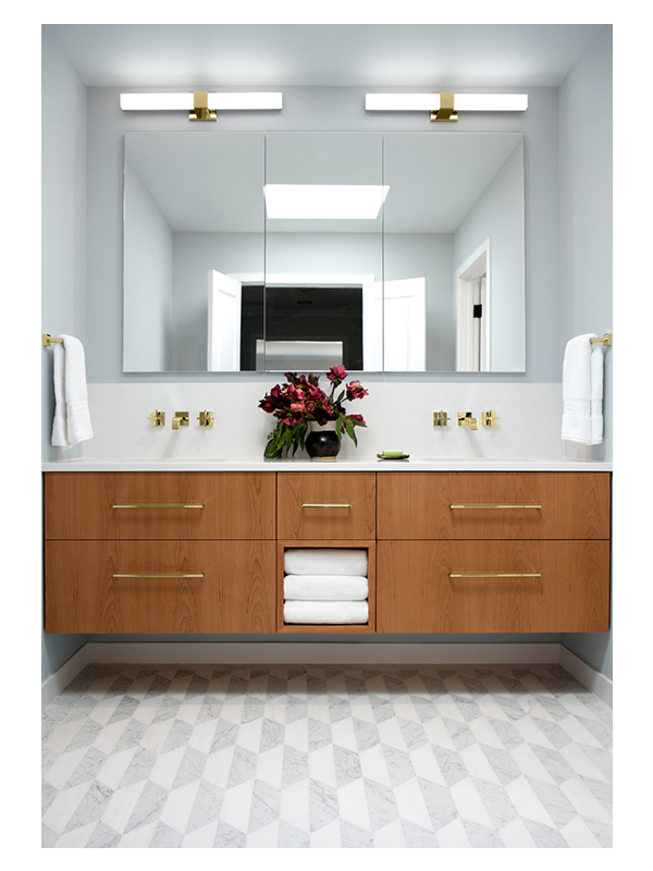 A grand master bathroom by Karen Blankenship Interiors, featuring the Art of Deco Chrysler Spire Solid pattern, made from White Whisp Dolomiti and Carrara Claro Light honed marble.